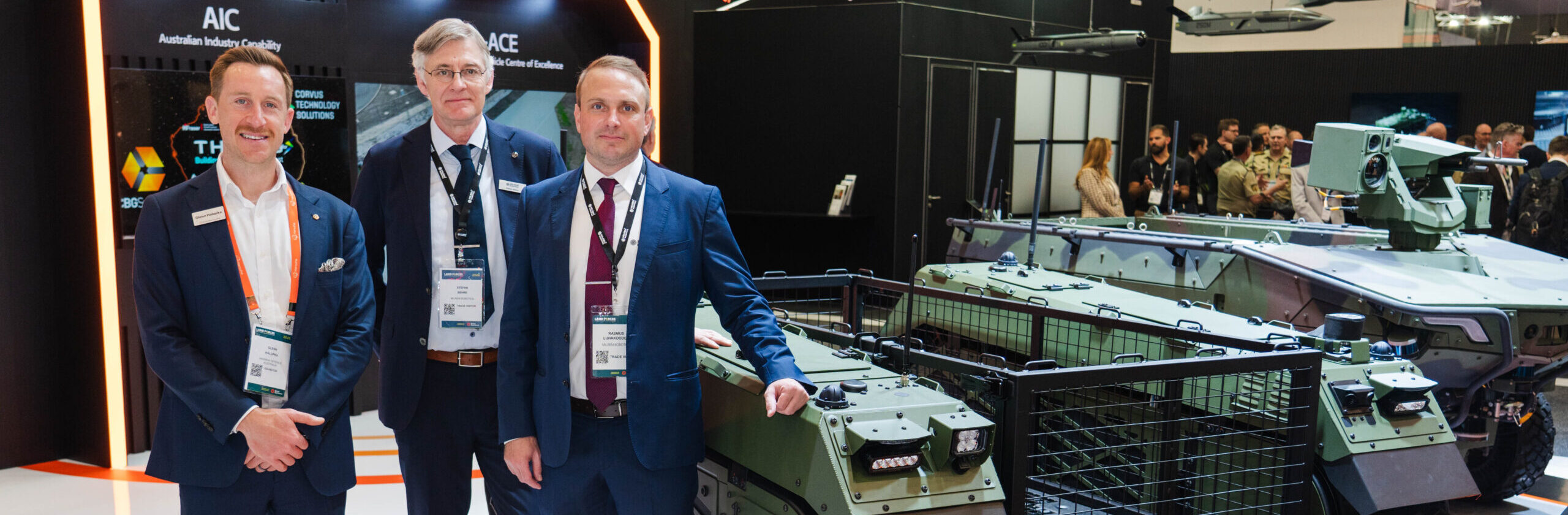Hanwha and Milrem Robotics representatives with the THeMIS unmanned ground vehicle at Land Forces Australia